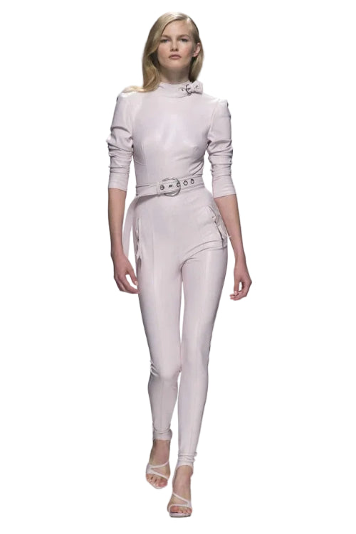 Model wearing a white outfit on a runway