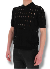 Person wearing a black outfit with gold patterns on a white background