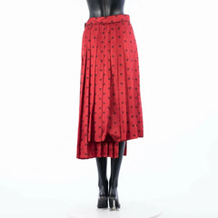 Red skirt with black pattern on a mannequin against a white background