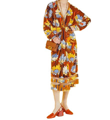 Person wearing a floral dress with a yellow background