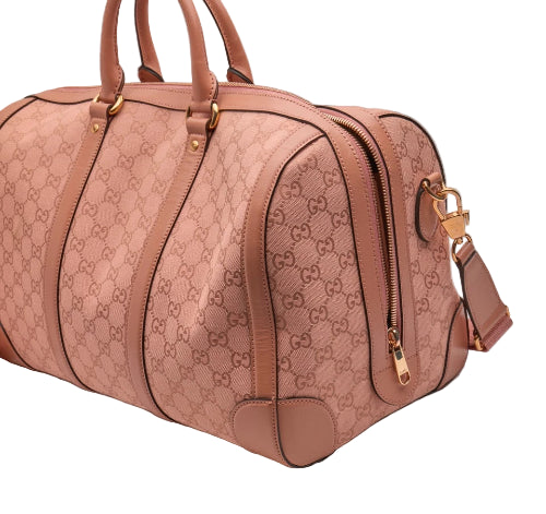 Pink Gucci handbag with gold accents on a light gray background