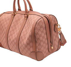 Pink Gucci handbag with gold accents on a light gray background