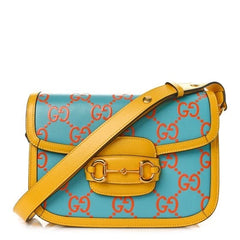 Blue handbag with yellow strap on a white background