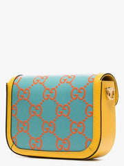 Designer handbag with a blue and orange pattern on a white background