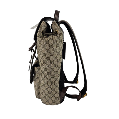 Beige and brown patterned backpack on a light gray background