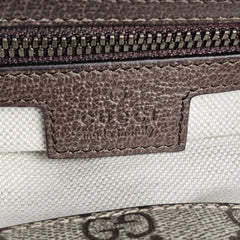 Close-up of Gucci logo on a textured surface
