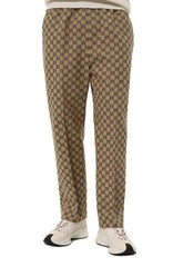 Beige pants with a pattern worn by a person on a white background