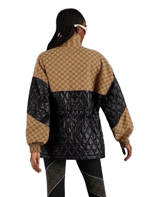 Person wearing a patterned jacket with a geometric design on a plain background