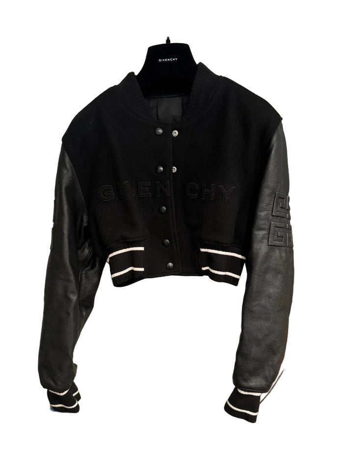 Black and gray jacket with Givenchy branding on a mannequin against a white wall.