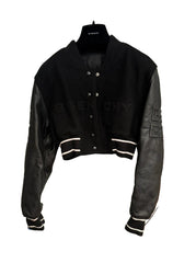 Black and gray jacket with Givenchy branding on a mannequin against a white wall.