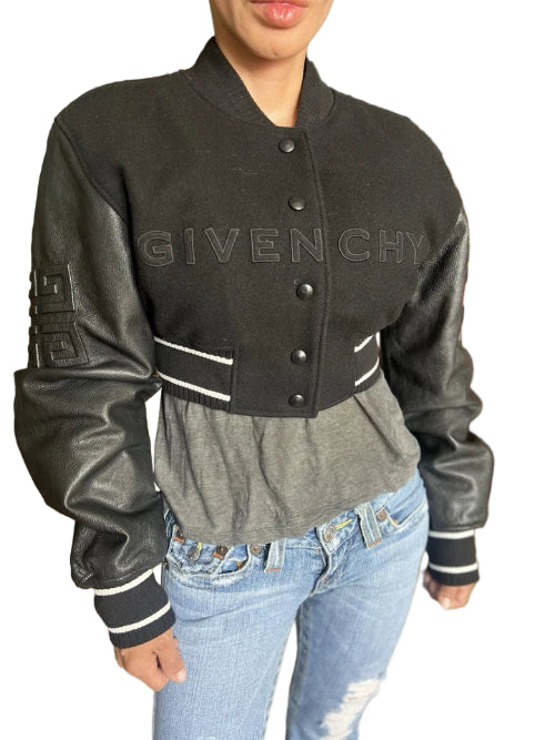 Person wearing a Givenchy jacket in an indoor setting with decorative elements.