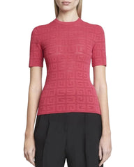 Red textured top worn by a person, with black pants, on a plain background