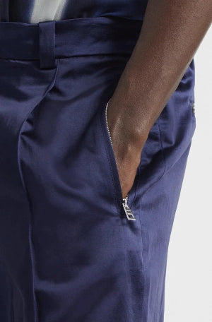 Navy blue pants with a zipper detail on a white background