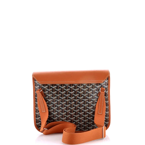 A Goyard messenger bag featuring the brand's signature navy and beige chevron pattern on the front, with smooth tan leather trim, a matching tan leather flap, and a tan leather shoulder strap.