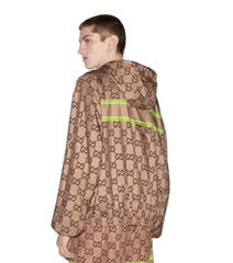 Person wearing a brown patterned raincoat with green accents on a white background
