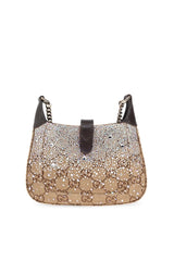 A Gucci monogram canvas shoulder bag in beige and brown, featuring a dark brown leather top handle and side straps, shown against a plain white background.