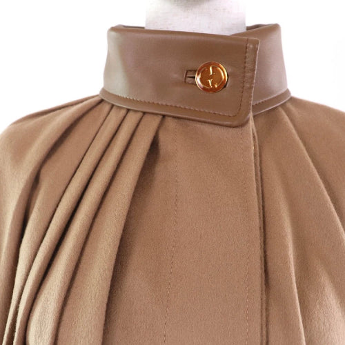 Close-up of a brown coat with a buttoned collar on a white background