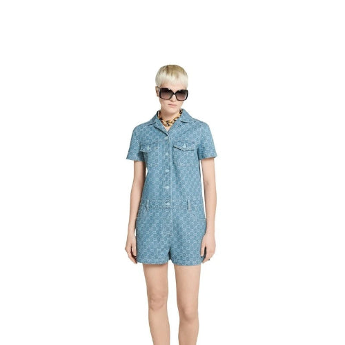 Woman wearing a blue dress with a pattern on a white background
