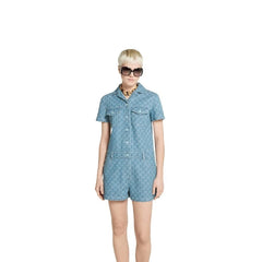 Woman wearing a blue dress with a pattern on a white background