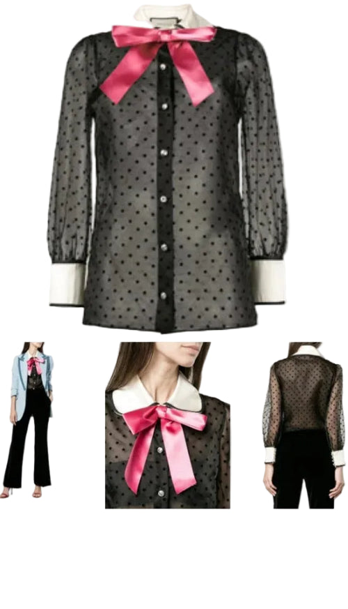 Black polka dot blouse with pink bow on a white background