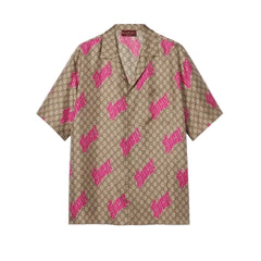 Beige shirt with pink Gucci logo pattern on a light gray background