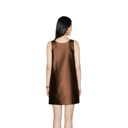 Woman wearing a brown dress against a white background