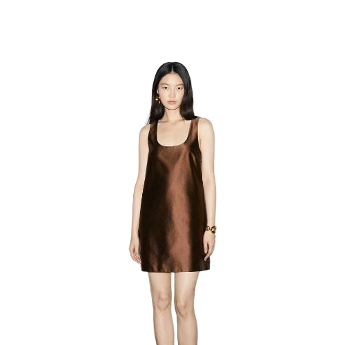 Woman wearing a brown slip dress on a white background