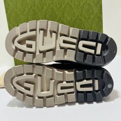 Gucci logo on the soles of shoes with a green box in the background