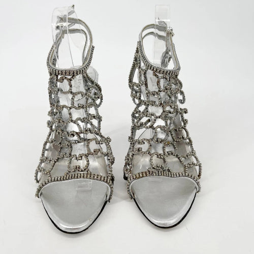 Silver high-heeled sandals on a white background