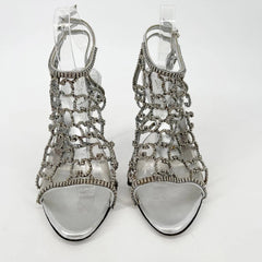 Silver high-heeled sandals on a white background