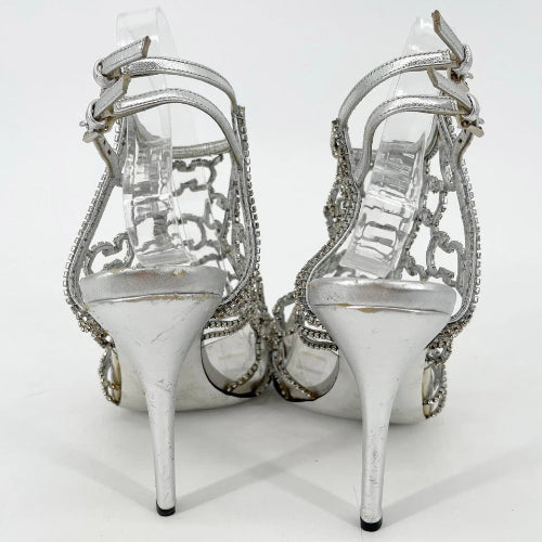Pair of silver high-heeled shoes on a clear background