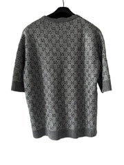 Gray patterned shirt on a hanger against a white background