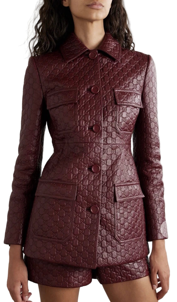 Quilted burgundy coat worn by a model on a white background