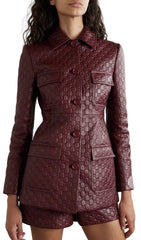 Quilted burgundy coat worn by a model on a white background