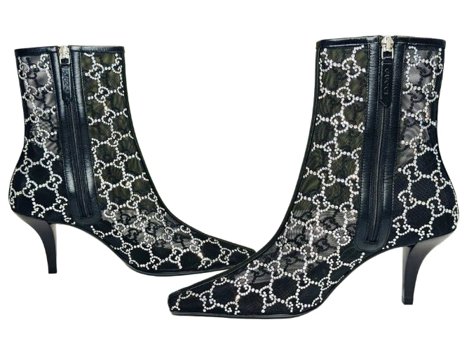 Black high-heeled boots with white pattern on a Gucci box