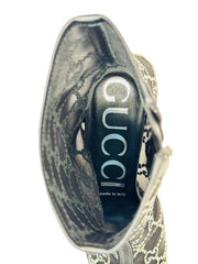 Gucci handbag with brand logo on a beige background