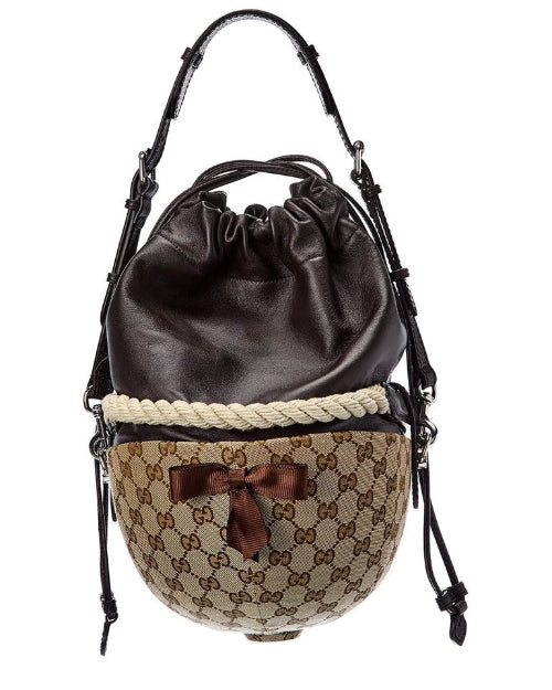 Designer handbag with brown leather top and patterned base on a white background