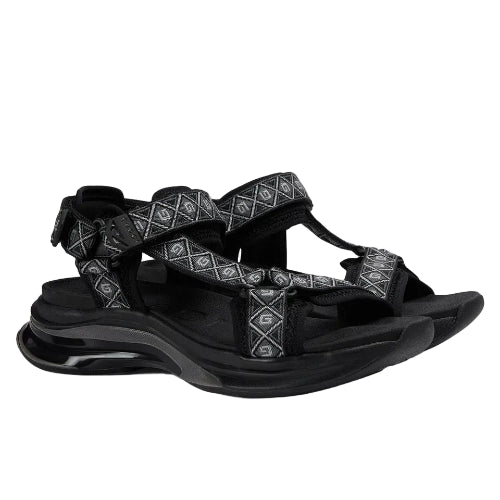 Black sandal with decorative elements on a white background