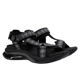 Black sandal with decorative elements on a white background