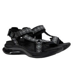 Black sandal with decorative elements on a white background