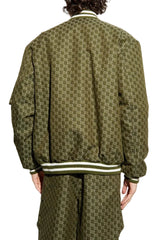 A person shown from the back wearing an olive green bomber jacket and matching pants with a repeating geometric monogram pattern and striped ribbed collar, cuffs, and hem.