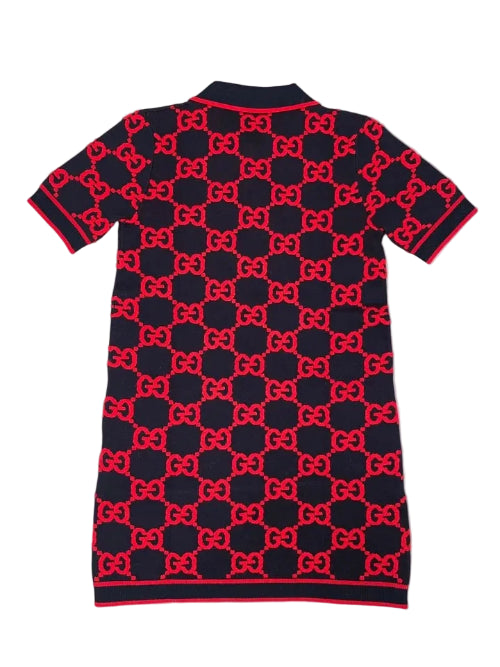 Navy blue dress with red bow pattern on a light gray background