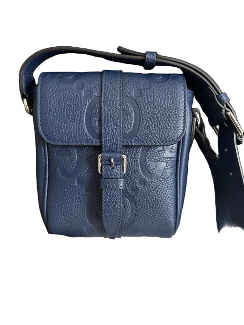 Blue Gucci handbag with a box and documentation on a dark surface