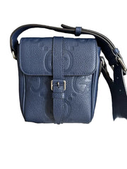 Blue Gucci handbag with a box and documentation on a dark surface