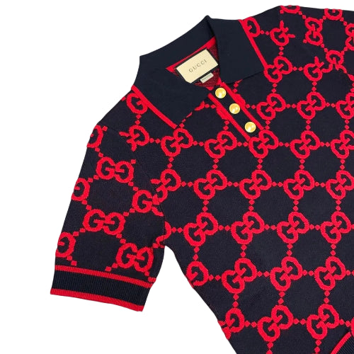 Black sweater with red pattern on a light gray background