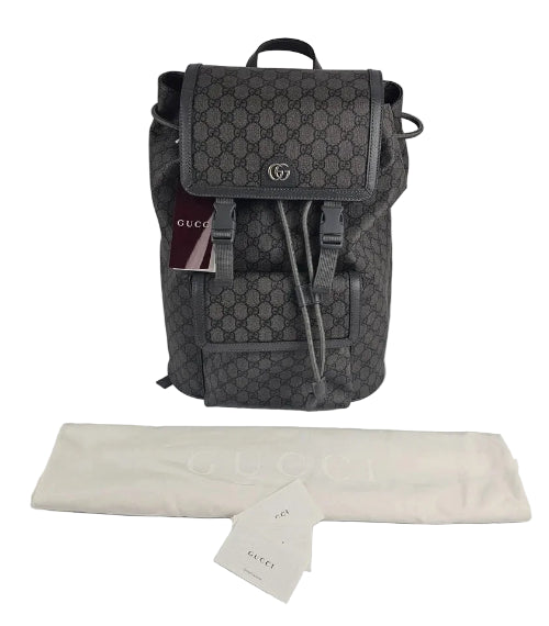 Gray Gucci backpack with a white cloth and tag on a light gray background