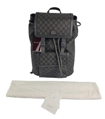 Gray Gucci backpack with a white cloth and tag on a light gray background