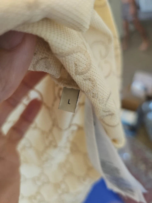 Close-up of a beige fabric with a label, blurred background