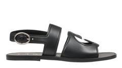 Black sandal with a metallic buckle on a white background