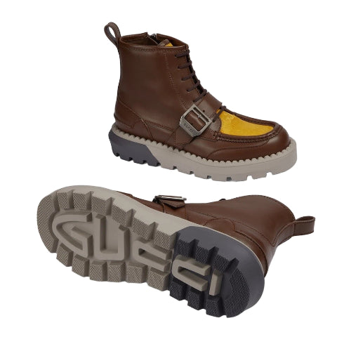 Brown leather boot with yellow sole on a light gray background